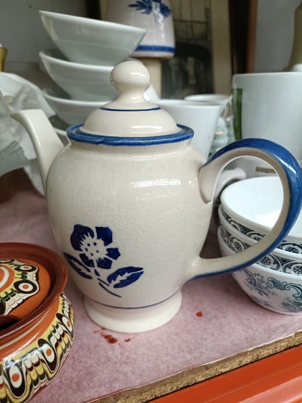 Tetera cerámica blanca con detalles azul y flor pintada